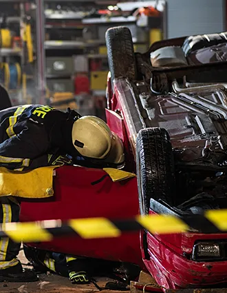 firefighter checking flipped car